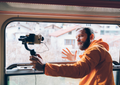 Travel influencer recording content during an international journey and sharing experiences abroad.