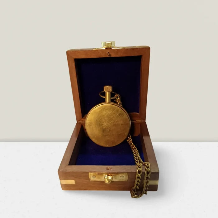Vintage pocket watch and chain on wooden box
